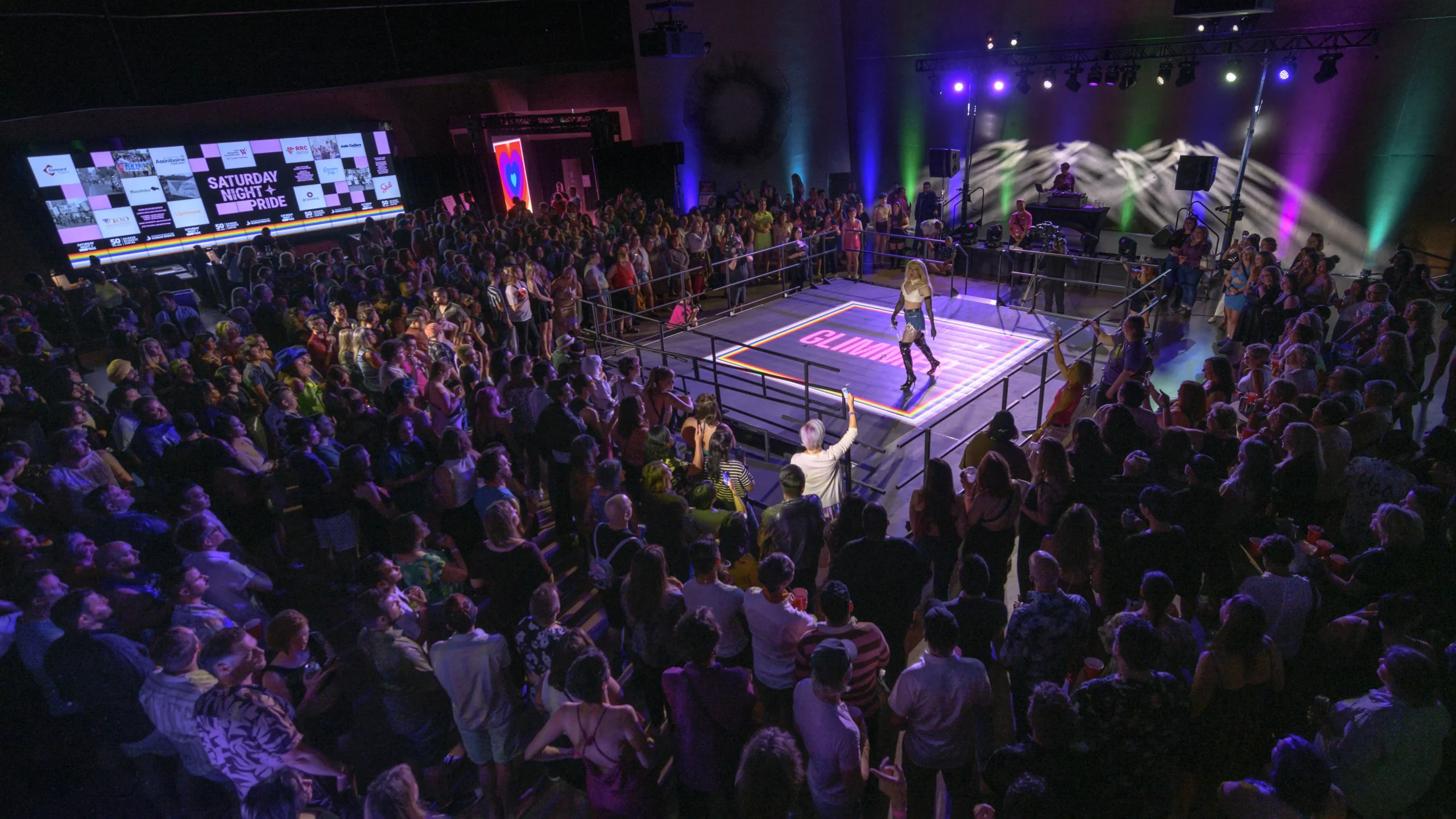 A packed AVentPro-produced event with an LED wall, runway stage, and full lighting rig