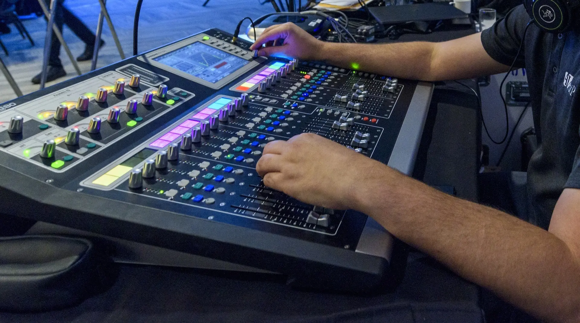 An AVentPro technician mixing audio on a digital console